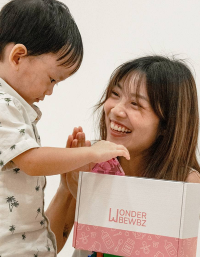 Mum and toddler opening a Wonderbewbz box